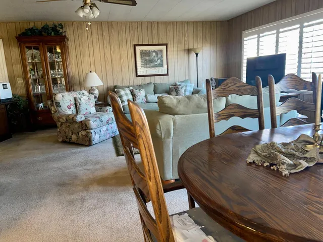 a view of a dining room with furniture and window