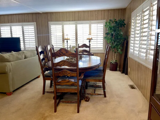 a living room with fireplace furniture and a large window