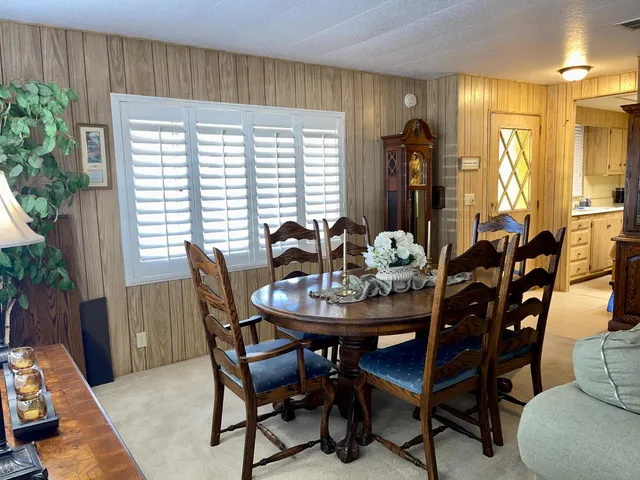 a living room with furniture a chandelier and a window