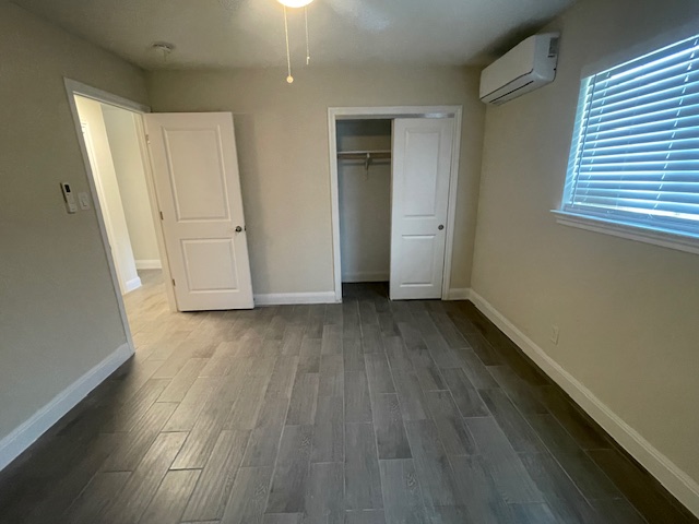 1403 Braes Ridge Drive, Unit B Austin, TX 78723 - Photo 5 of 6 an empty room with wooden floor and windows