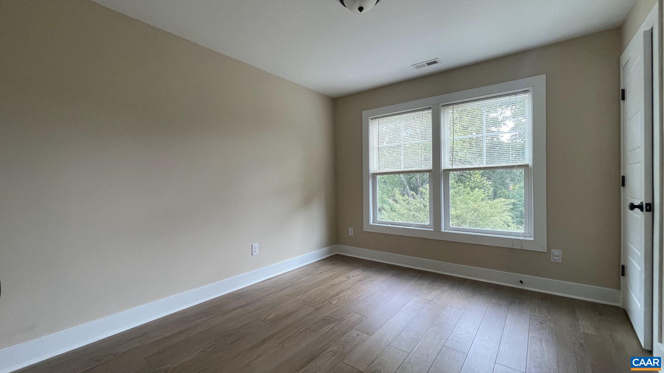 200 Harris Road Charlottesville, VA 22903 - Photo 26 of 28 an empty room with wooden floor and windows
