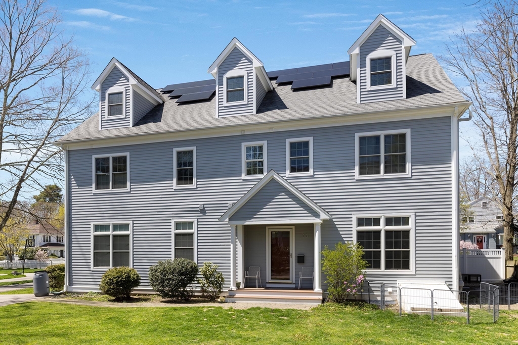 38 Maple Street, Unit 38 Needham, MA 02492 - Photo 1 of 14 a front view of a house with a yard