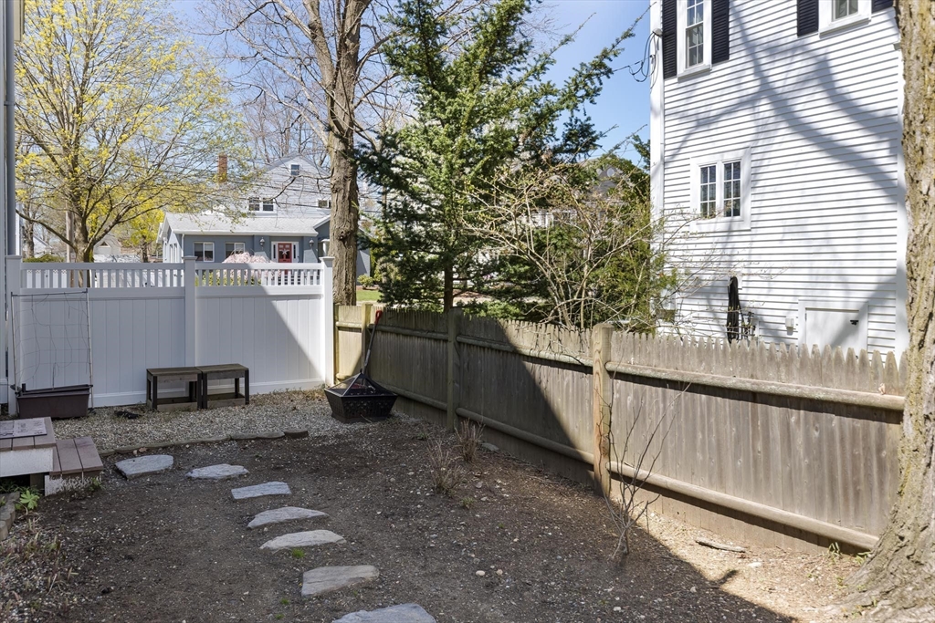 38 Maple Street, Unit 38 Needham, MA 02492 - Photo 12 of 14 a view of a street with wooden fence