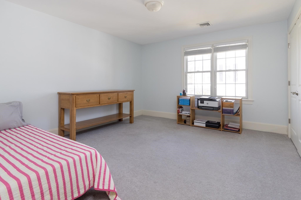 38 Maple Street, Unit 38 Needham, MA 02492 - Photo 7 of 14 a bedroom with a bed and a chair