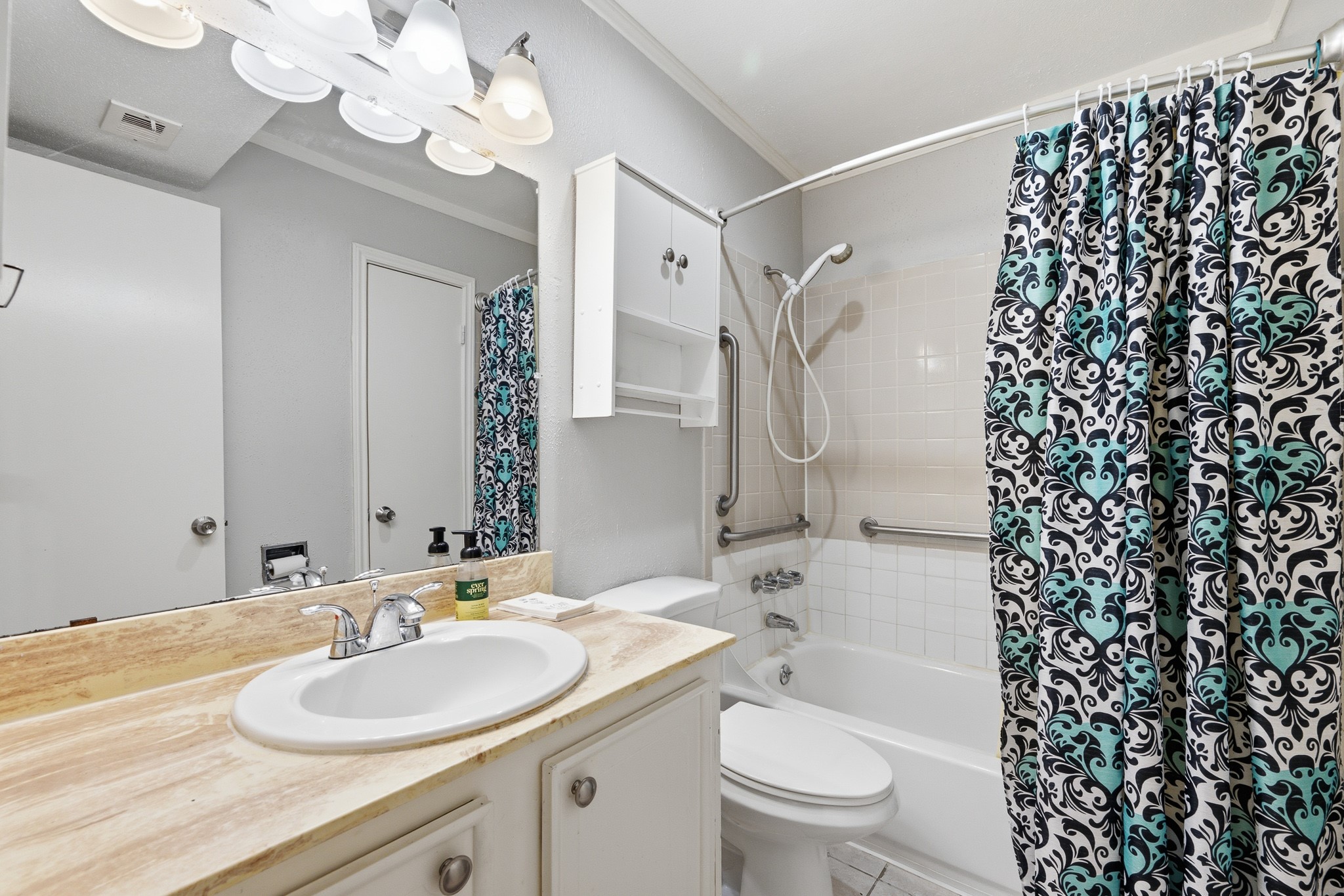 11550 Chimney Rock Road, Unit 133 Houston, TX 77035 - Photo 22 of 40 Bright bathroom featuring a spacious vanity with ample storage, elegant tile flooring, and a stylish shower-tub combination.