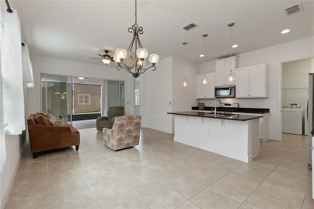 a living room with kitchen and furniture