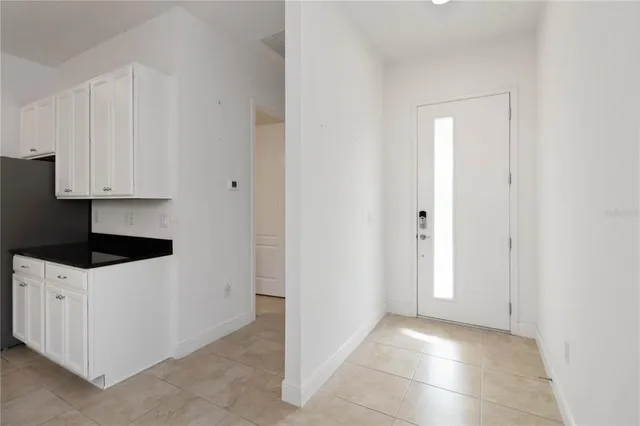 a kitchen with white cabinets and white appliances