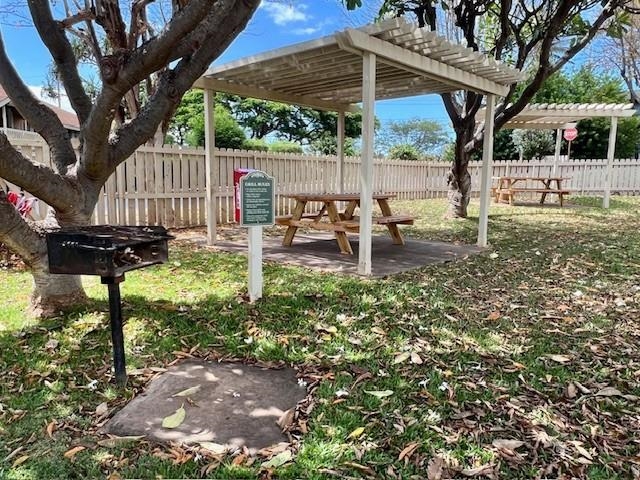 140 Uwapo Road, Unit 21101 Kihei, HI 96753 - Photo 6 of 12 a backyard of a house with table and chairs