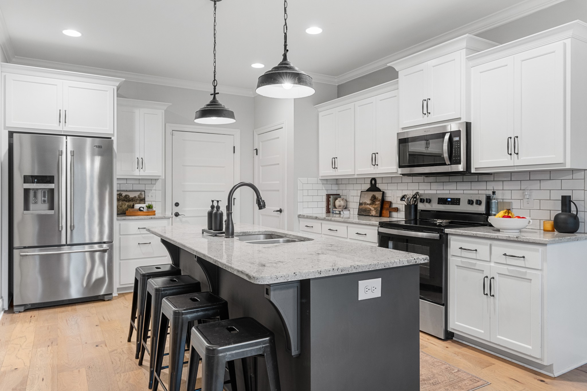 111 Flat Woods Road Lebanon, TN 37090 - Photo 12 of 60 a kitchen with stainless steel appliances granite countertop a stove a sink dishwasher a refrigerator with white cabinets and wooden floor