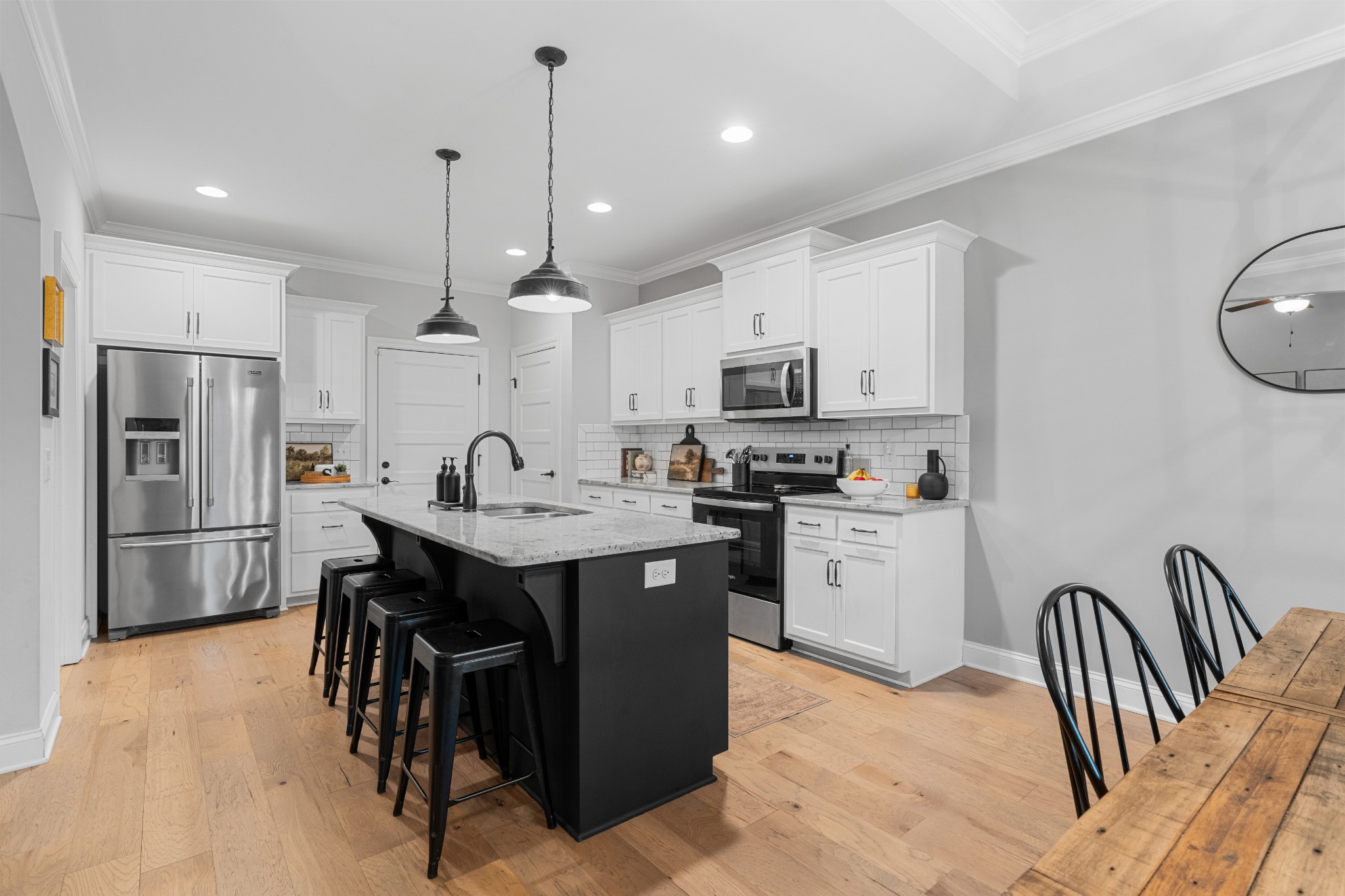 111 Flat Woods Road Lebanon, TN 37090 - Photo 13 of 60 a kitchen with stainless steel appliances granite countertop a stove a sink a refrigerator and white cabinets with wooden floor