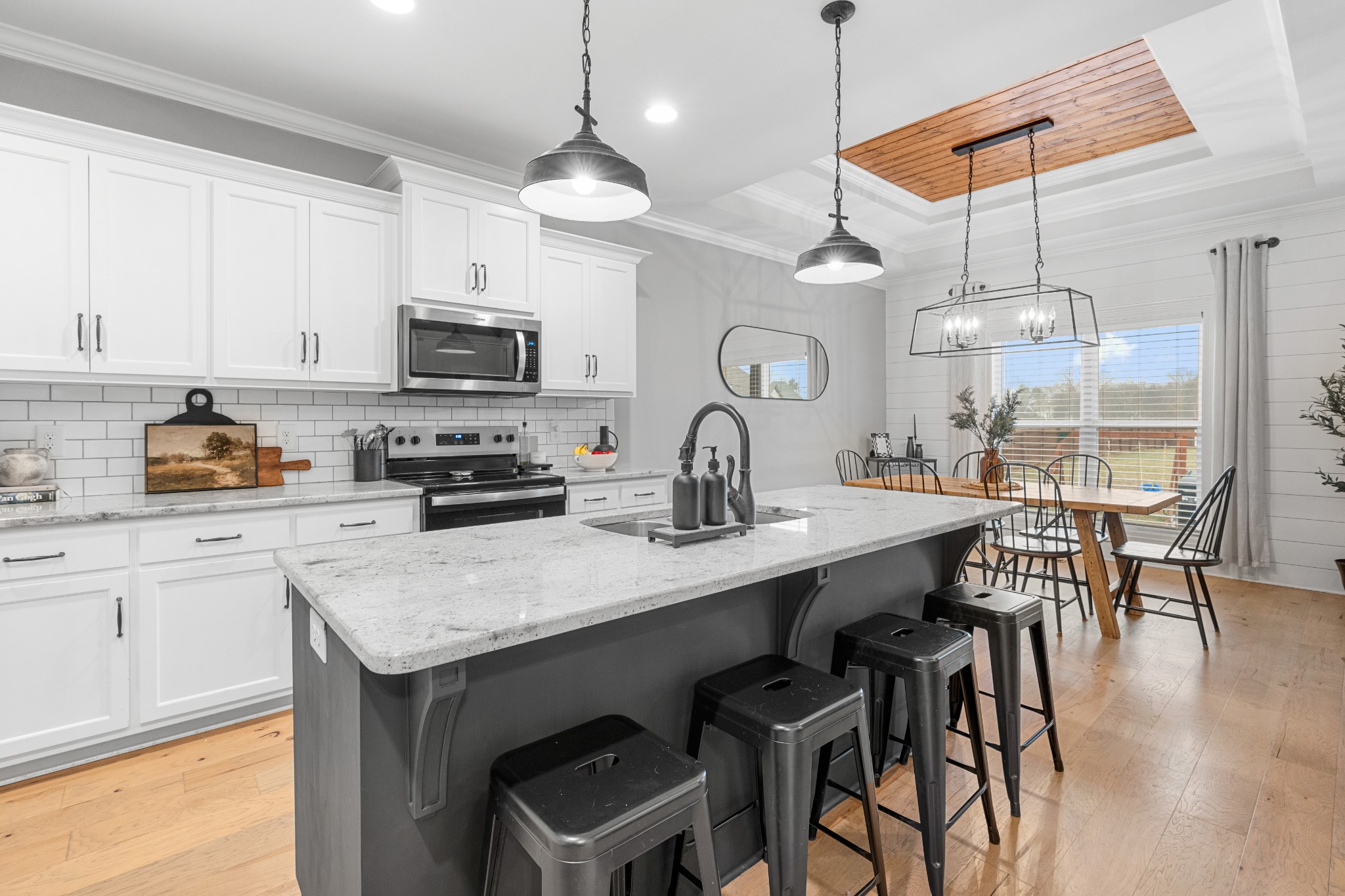 111 Flat Woods Road Lebanon, TN 37090 - Photo 18 of 60 a kitchen with stainless steel appliances granite countertop a kitchen island a stove a table and chairs in it