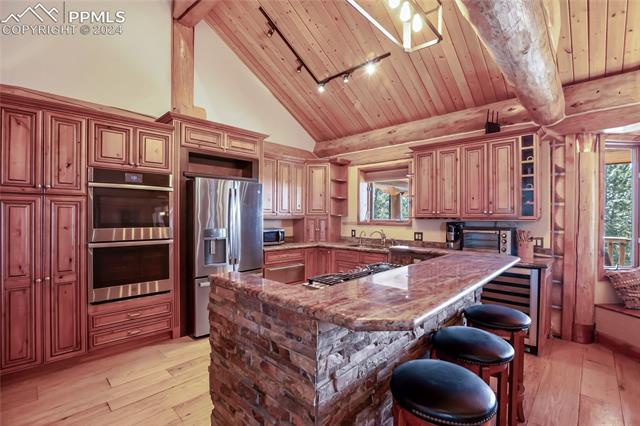 616 Summit Road Hartsel, CO 80449 - Photo 21 of 50 Kitchen with wood ceiling, beam ceiling, light hardwood / wood-style flooring, and stainless steel appliances