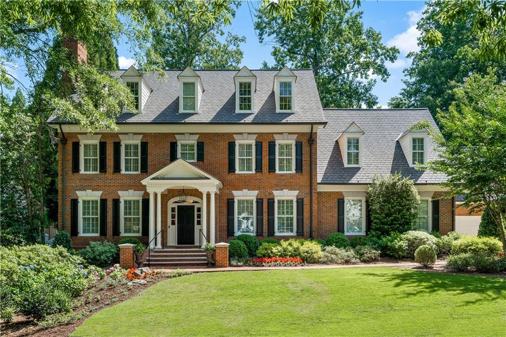 1194 Brookgate Way Northeast Brookhaven, GA 30319 - Photo 1 of 1 front view of a brick house with a yard