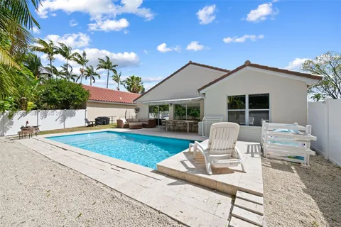 a view of a patio with table and chairs with wooden fence