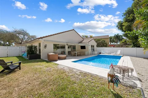 a view of a house with swimming pool and sitting area