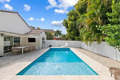 a view of a patio with table and chairs with wooden floor and fence
