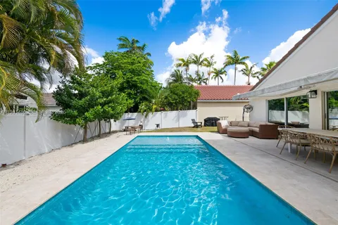 a swimming pool with outdoor seating and yard