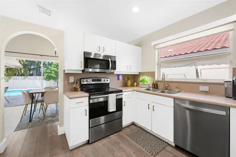 a kitchen with a sink stove and microwave