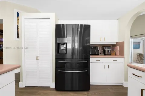 a kitchen with stainless steel appliances a refrigerator and cabinets