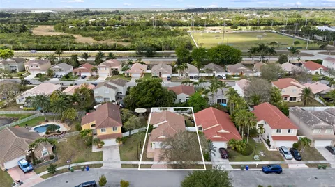 an aerial view of residential houses with outdoor space