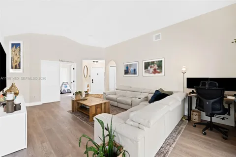a living room with furniture and wooden floor