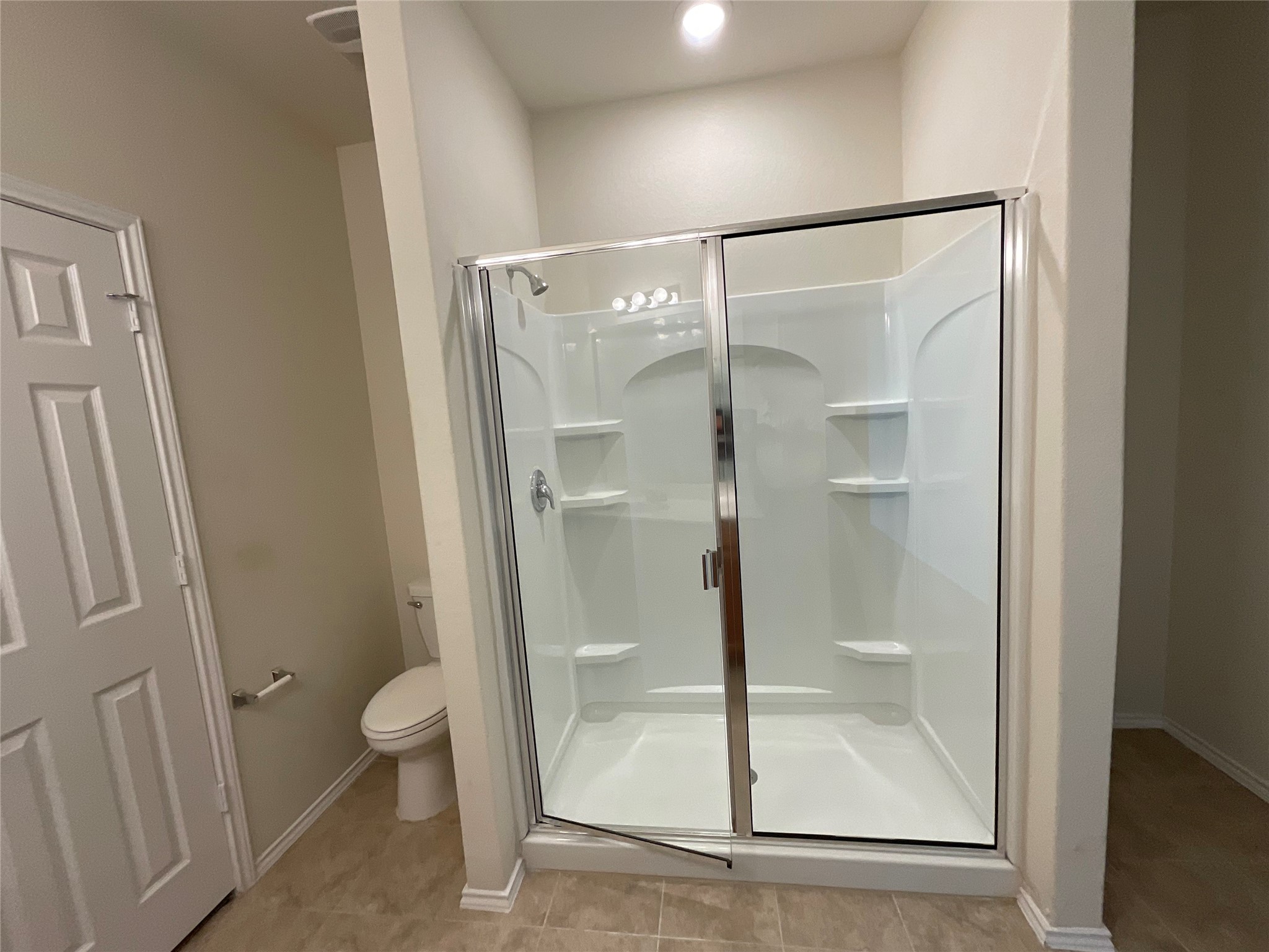 3451 Mayfield Ranch Boulevard, Unit 311 Round Rock, TX 78681 - Photo 17 of 29 Bathroom featuring a shower stall and toilet