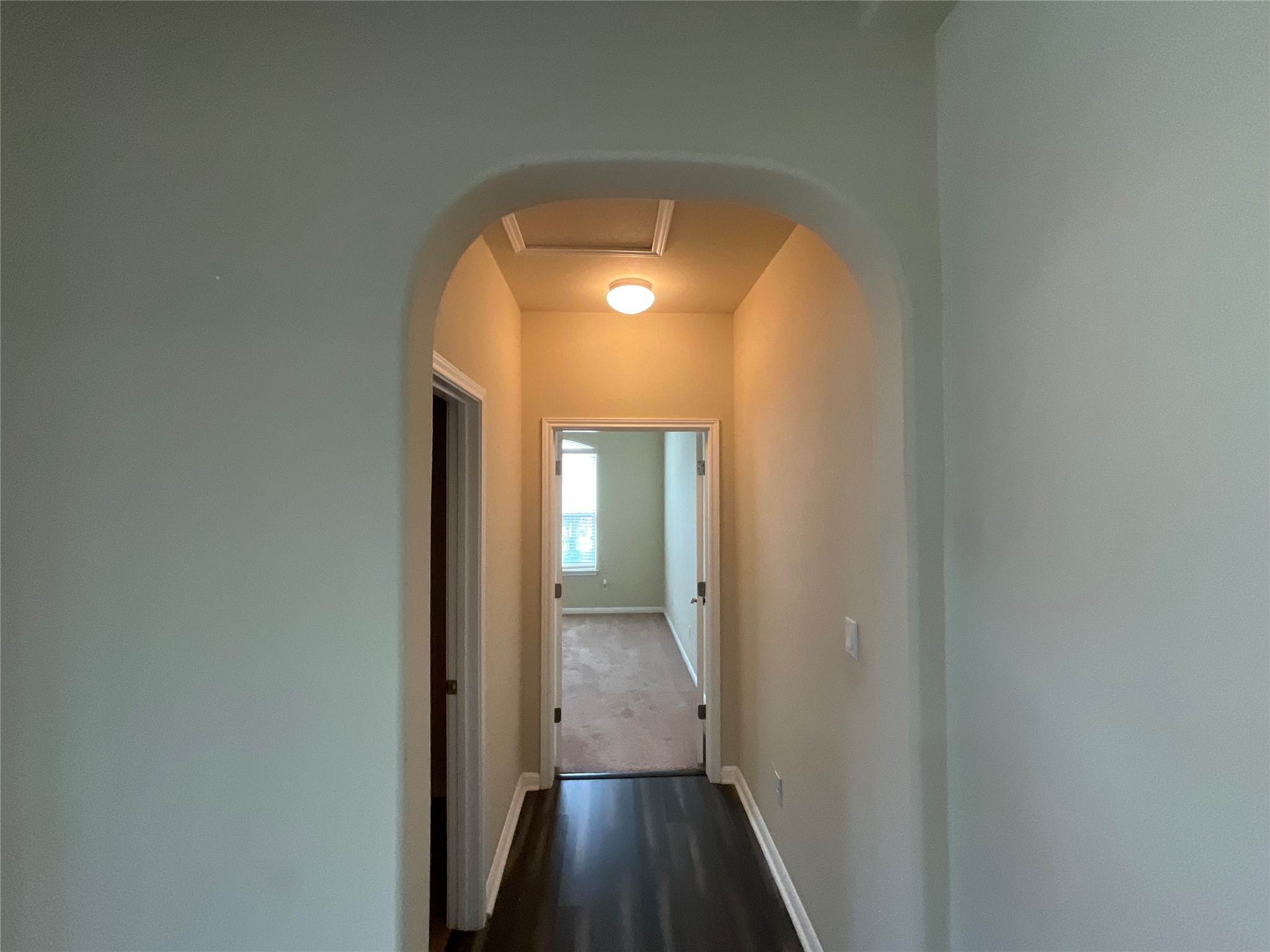 3451 Mayfield Ranch Boulevard, Unit 311 Round Rock, TX 78681 - Photo 18 of 29 Corridor with arched walkways and dark wood-style floors