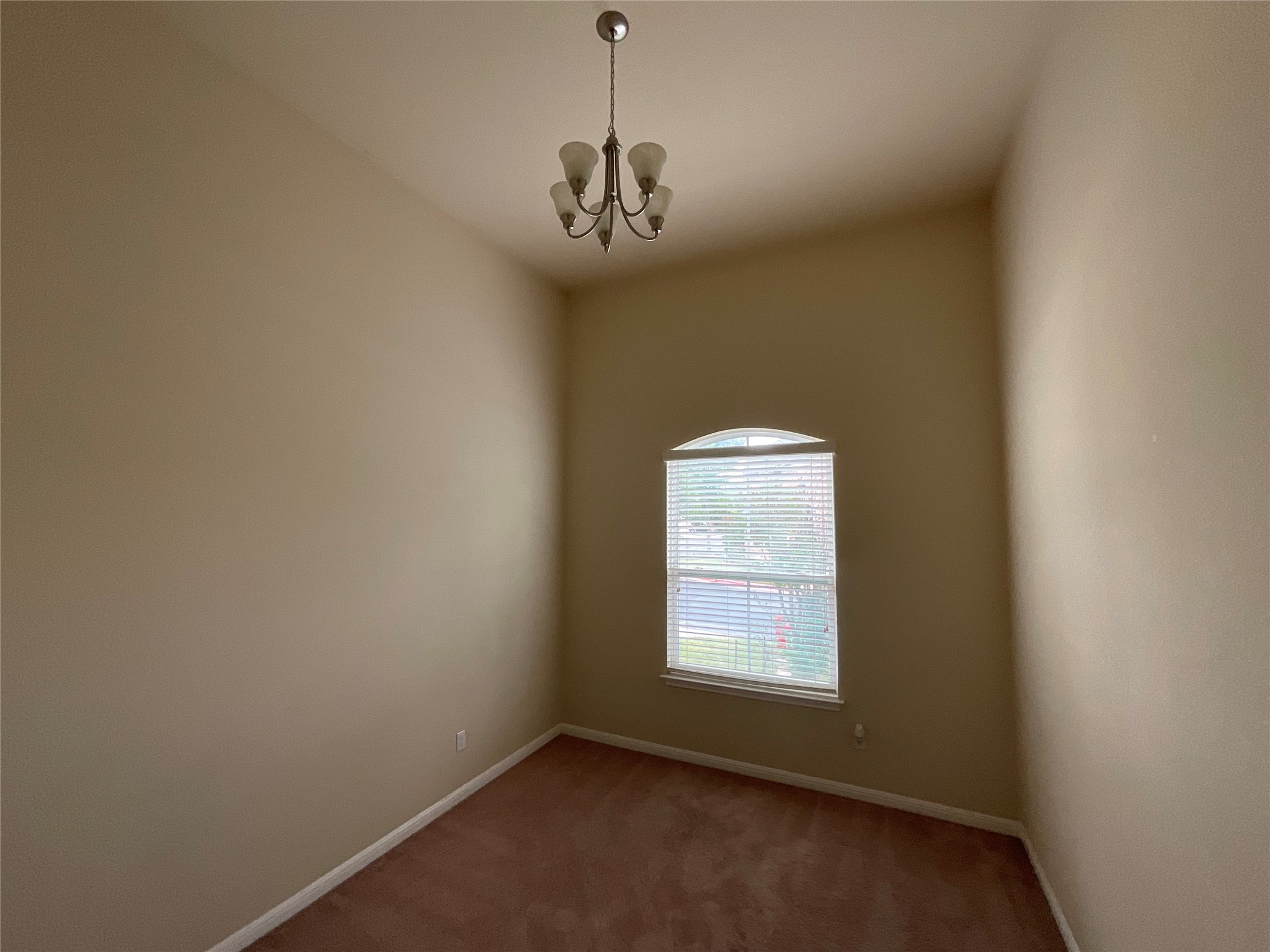 3451 Mayfield Ranch Boulevard, Unit 311 Round Rock, TX 78681 - Photo 19 of 29 Carpeted empty room featuring hanging lights and baseboards