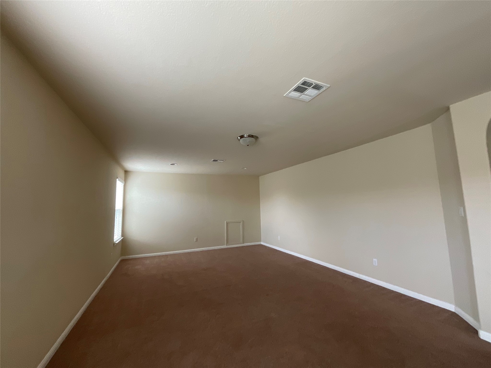 3451 Mayfield Ranch Boulevard, Unit 311 Round Rock, TX 78681 - Photo 22 of 29 Unfurnished room with dark colored carpet and arched walkways