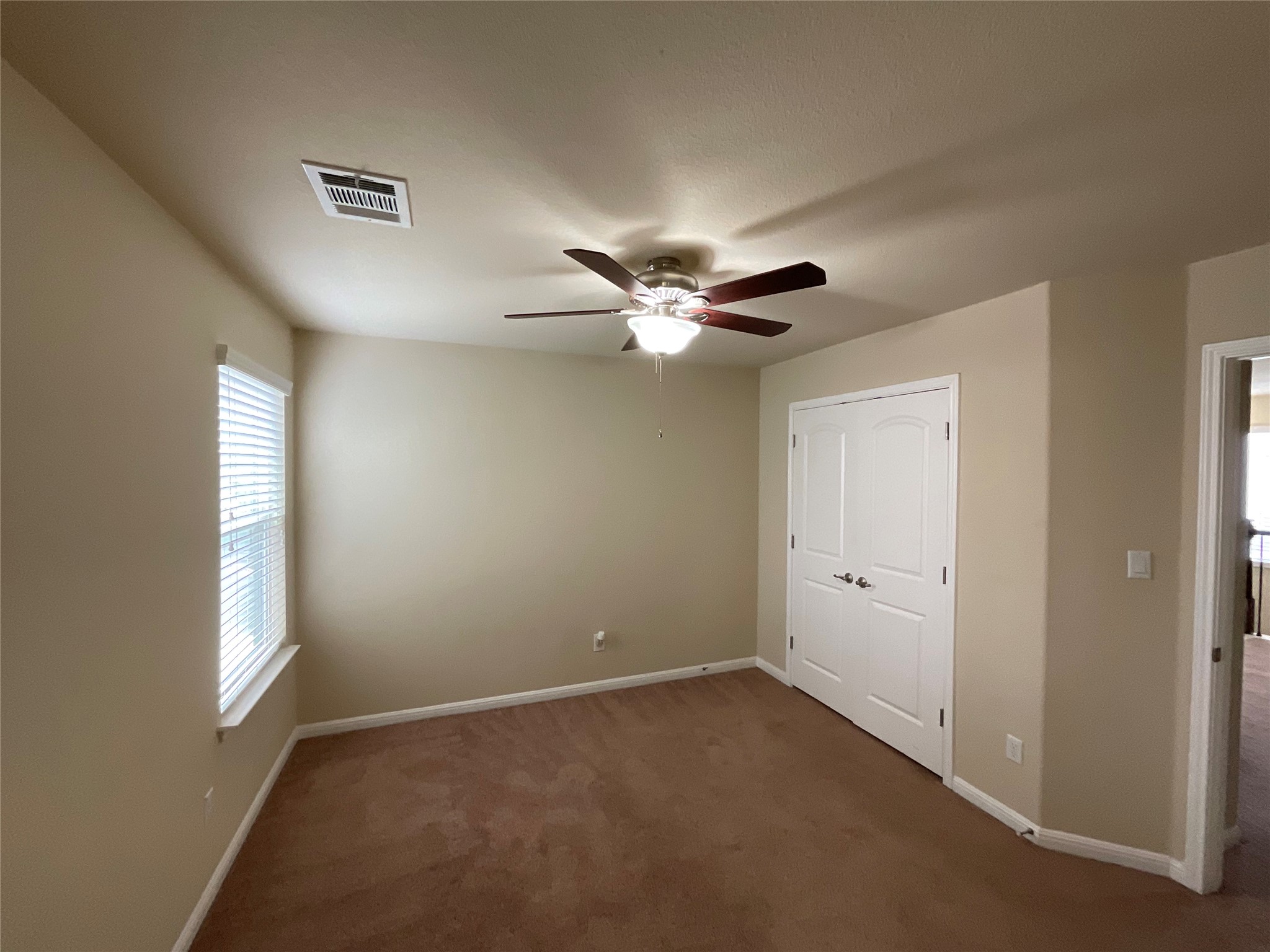 3451 Mayfield Ranch Boulevard, Unit 311 Round Rock, TX 78681 - Photo 23 of 29 Unfurnished bedroom with a closet, dark carpet, and a ceiling fan