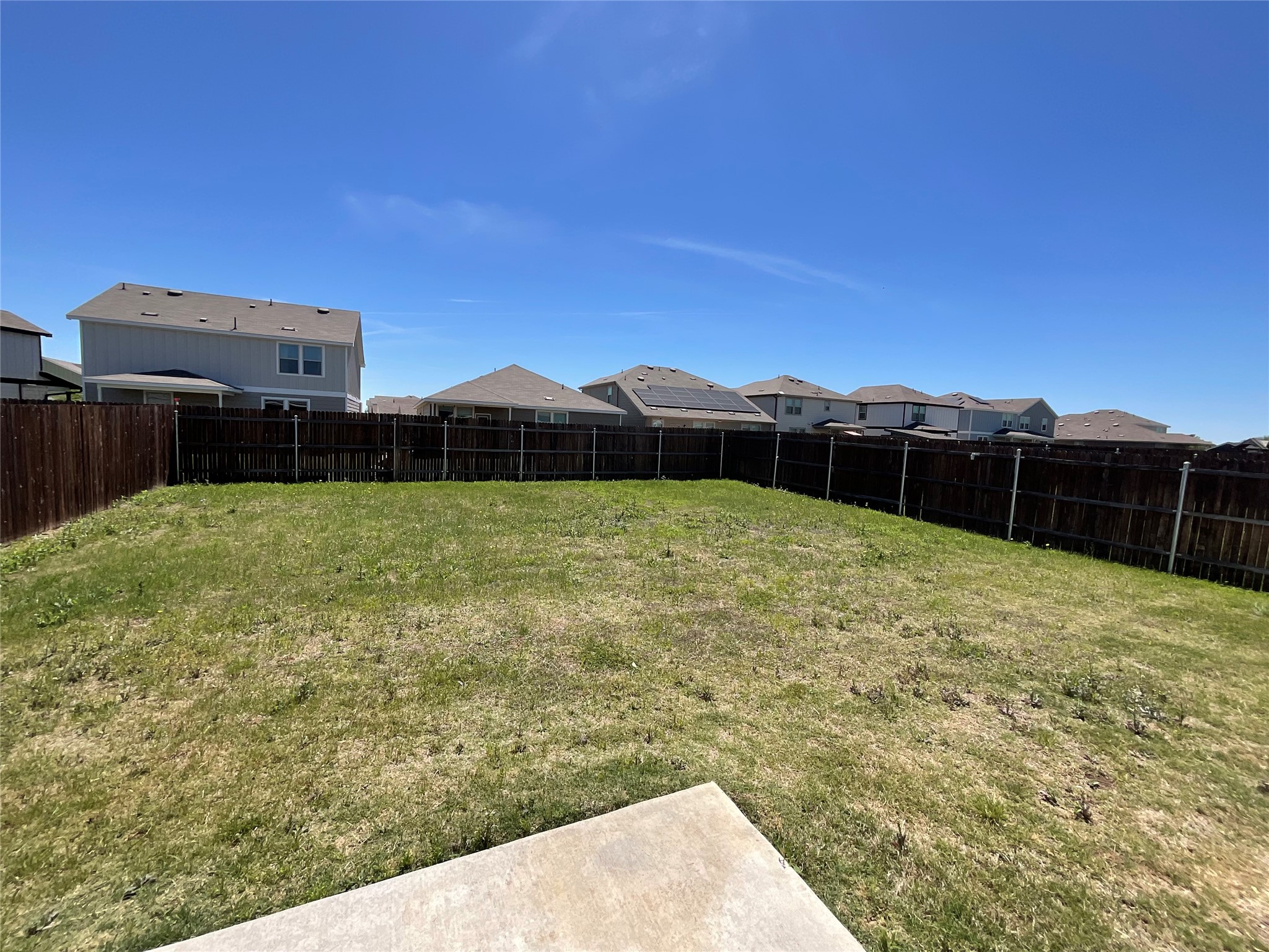 3451 Mayfield Ranch Boulevard, Unit 311 Round Rock, TX 78681 - Photo 29 of 29 Fenced backyard with a residential view