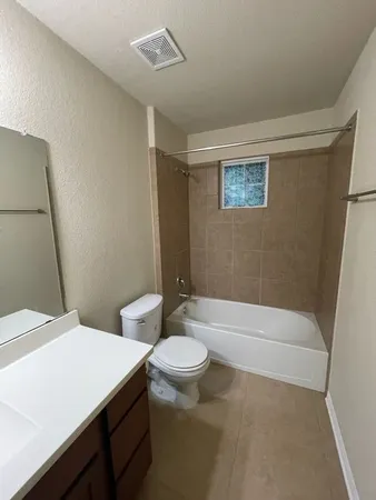 a bathroom with a sink a toilet and mirror