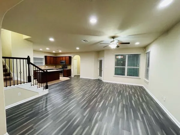 a view of a livingroom with furniture wooden floor and chandelier