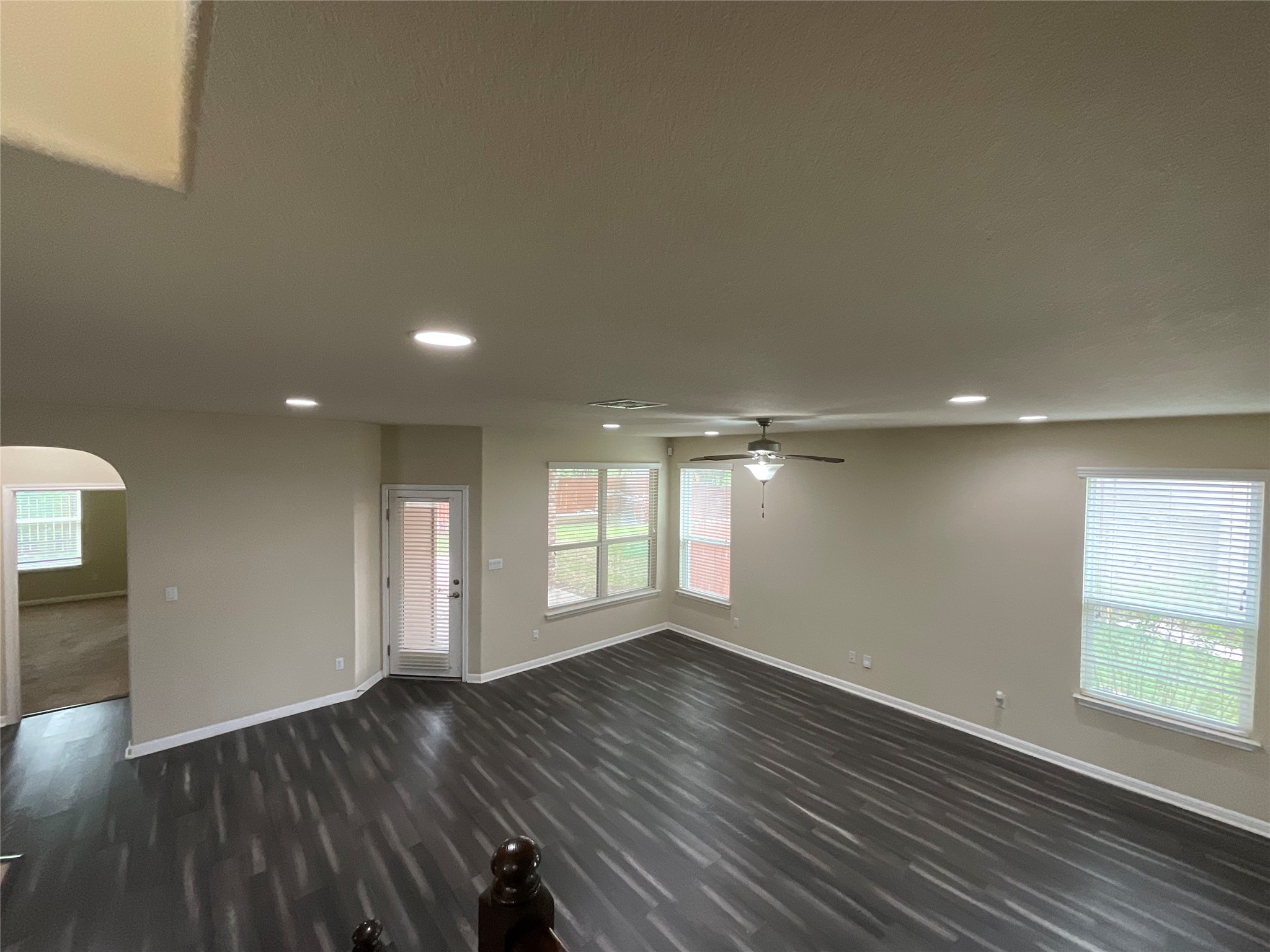 3451 Mayfield Ranch Boulevard, Unit 311 Round Rock, TX 78681 - Photo 6 of 29 Unfurnished room featuring arched walkways, recessed lighting, dark wood-style flooring, and a ceiling fan
