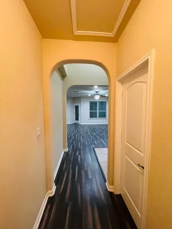 a view of a hallway with wooden floor