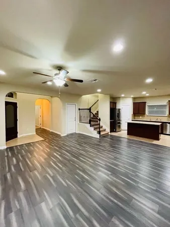 a view of kitchen with cabinets and refrigerator