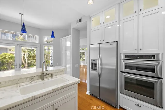 a kitchen with stainless steel appliances granite countertop a refrigerator and a sink