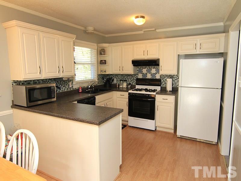 1822 Stage Road Durham, NC 27703 - Photo 5 of 16 Updated kitchen with gas range, DW, Refrigerator and Tiled backsplash!