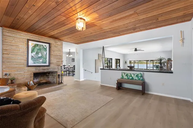 a kitchen with stainless steel appliances kitchen island granite countertop a sink a stove and white cabinets