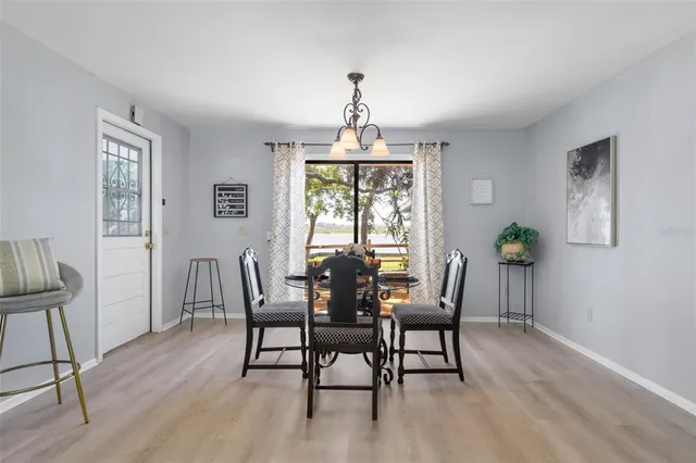 a view of a patio with table and chairs with wooden floor and fence