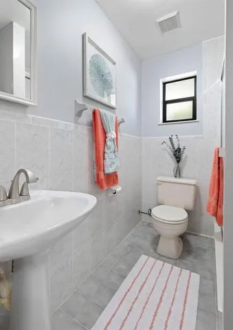 an aerial view of residential house with outdoor space and trees all around