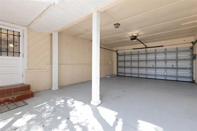 an aerial view of a residential houses with outdoor space and lake view