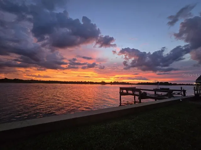 a living room with furniture a fireplace and a large window