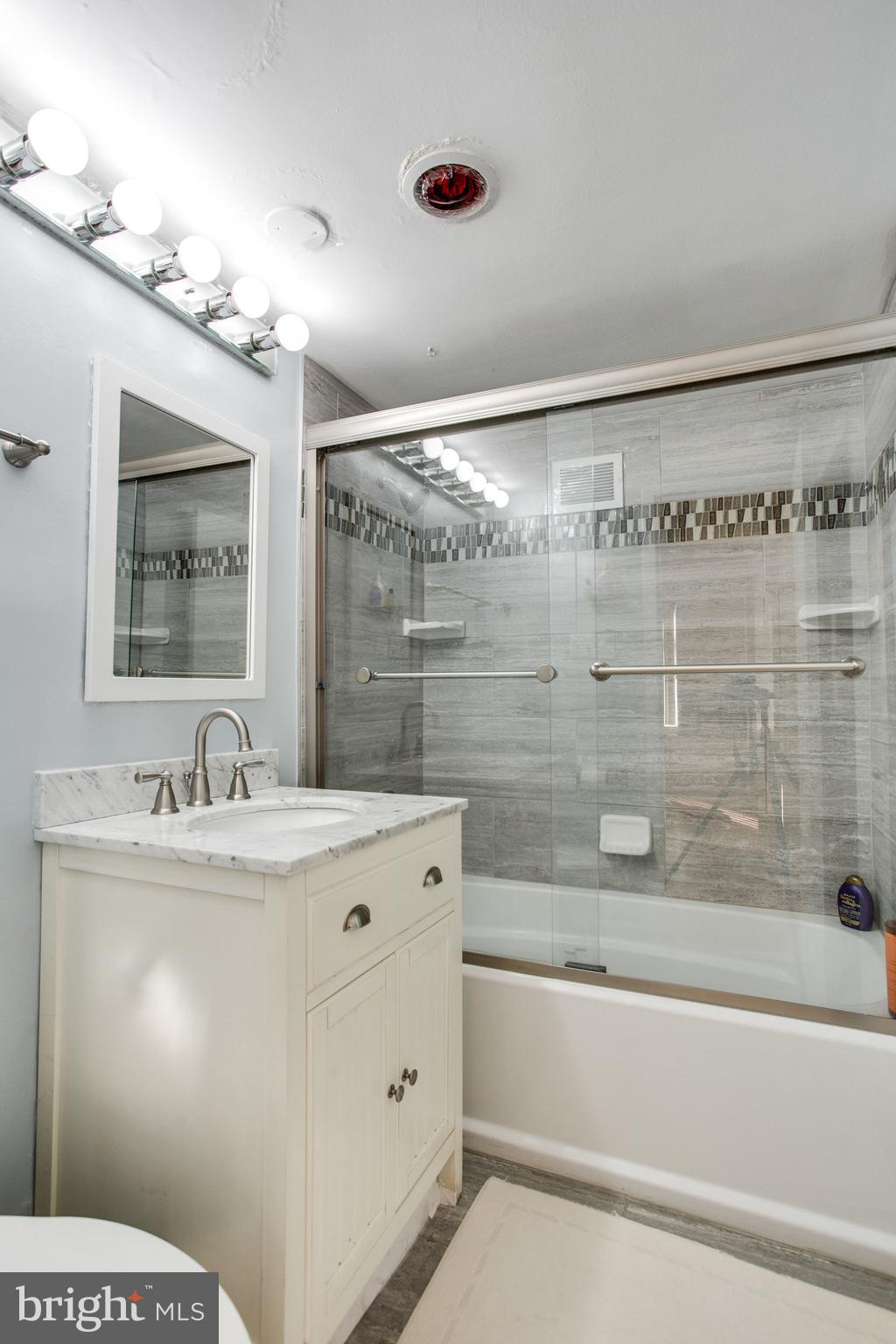 2401 H Street Northwest, Unit 202 Washington, DC 20037 - Photo 8 of 23 a bathroom with a sink a large mirror and a shower