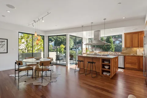 a view of a balcony dining table and chairs