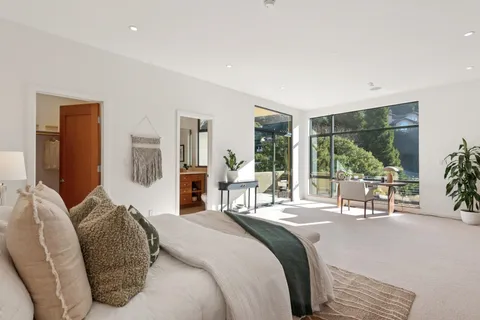 a view of a patio with couches table and chairs and potted plants
