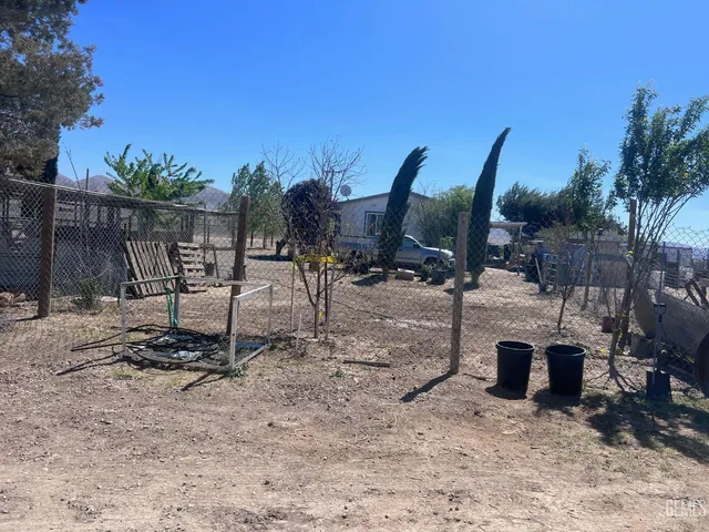 a view of a backyard with a table and chairs