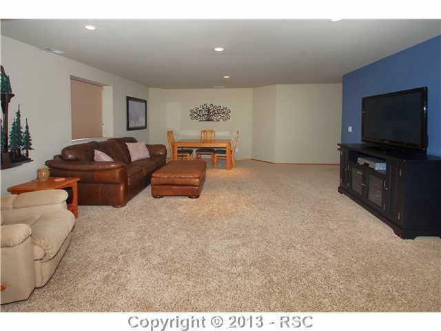 7780 Julynn Road Colorado Springs, CO 80919 - Photo 17 of 25 Spacious Family Room - Perfect for Watching Movies or Playing Games