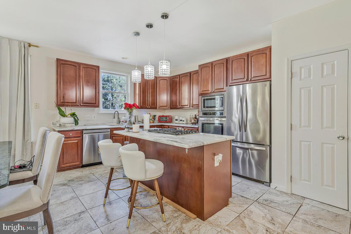 215 Hoile Lane Huntingtown, MD 20639 - Photo 14 of 52 a kitchen with stainless steel appliances granite countertop a refrigerator a stove a sink and a refrigerator