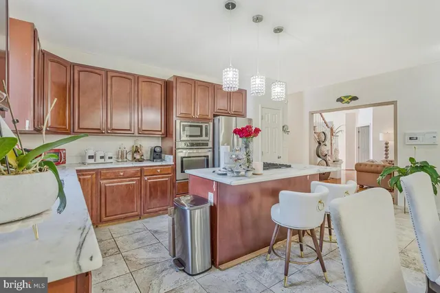 a room with furniture a flat screen tv and kitchen view